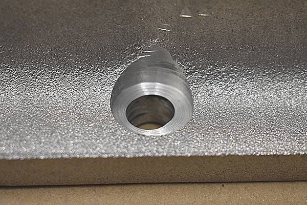 One of the bolt holes that is machined incorrectly.