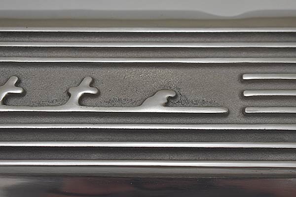 Rough surface around script of second valve cover.