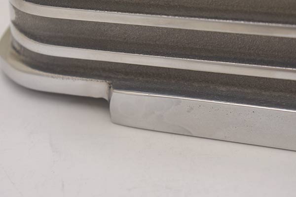 The lip below the script of first valve cover is slanted.