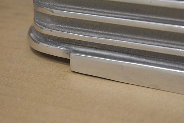 The lip below the script of second valve cover is slanted.