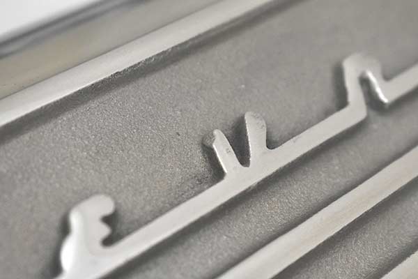 A small chip on the 'V' script on the first valve cover.