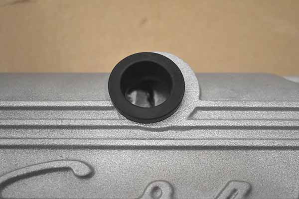 A grommet inserted in the breather hole that is not centered.