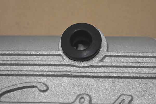 A grommet inserted in the PCV hole that is not centered.