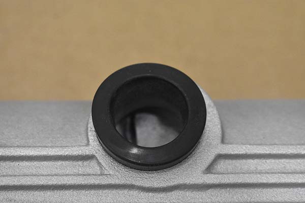 A grommet inserted in the breather hole that is not centered.