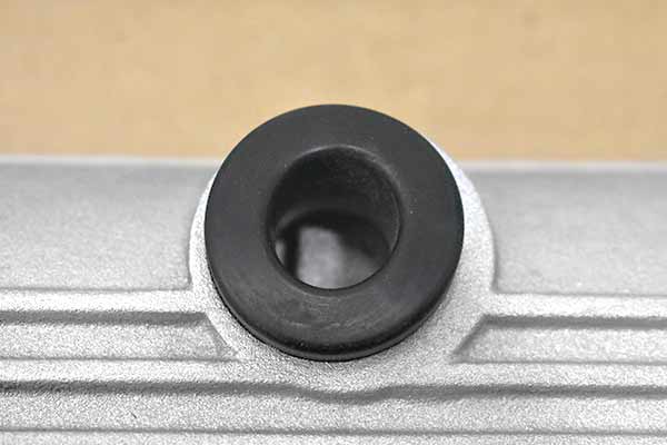 A grommet inserted in the PCV hole that is not centered.