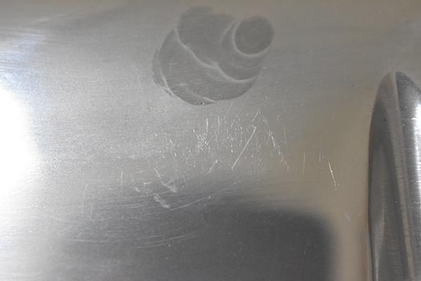 Some small scratches under dark spot on exhaust side of second valve cover.