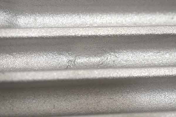 A casting blemish between fins on top of transmission pan.