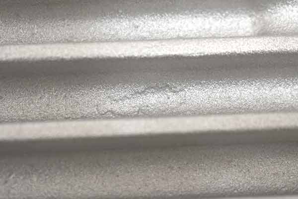 Another casting blemish between fins on top of transmission pan.