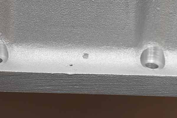 A small pit on surface of transmission pan.