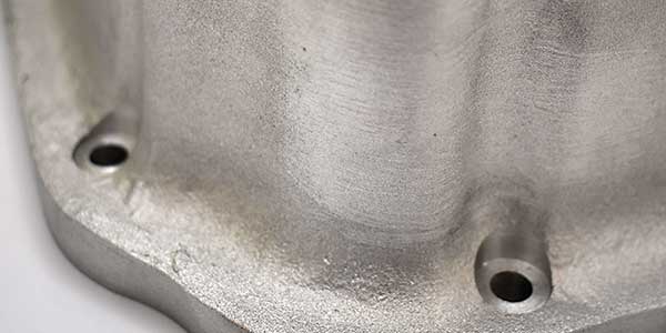 Rough surface on side of transmission pan.