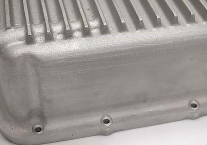 Some concave areas and scratches at end of fins on transmission pan.