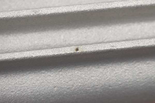 A small pit on fin of transmission pan.