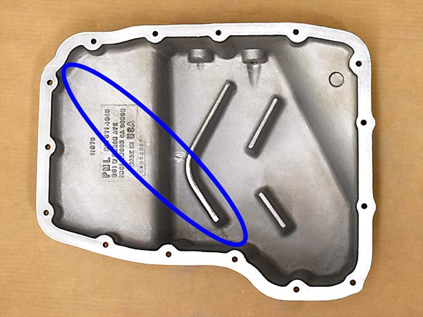 Inside of transmission pan highlighting blemished area.